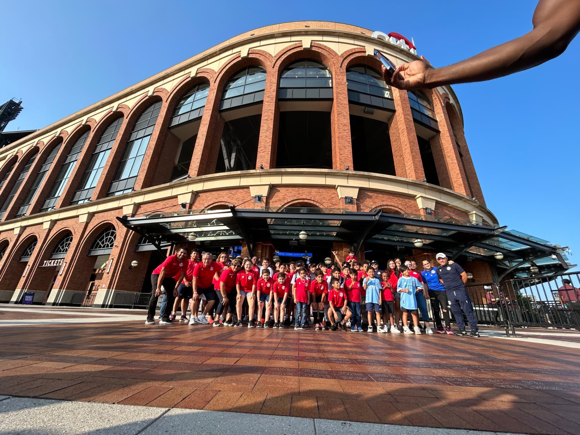 YES players and coaches together outside Citi Field before a game